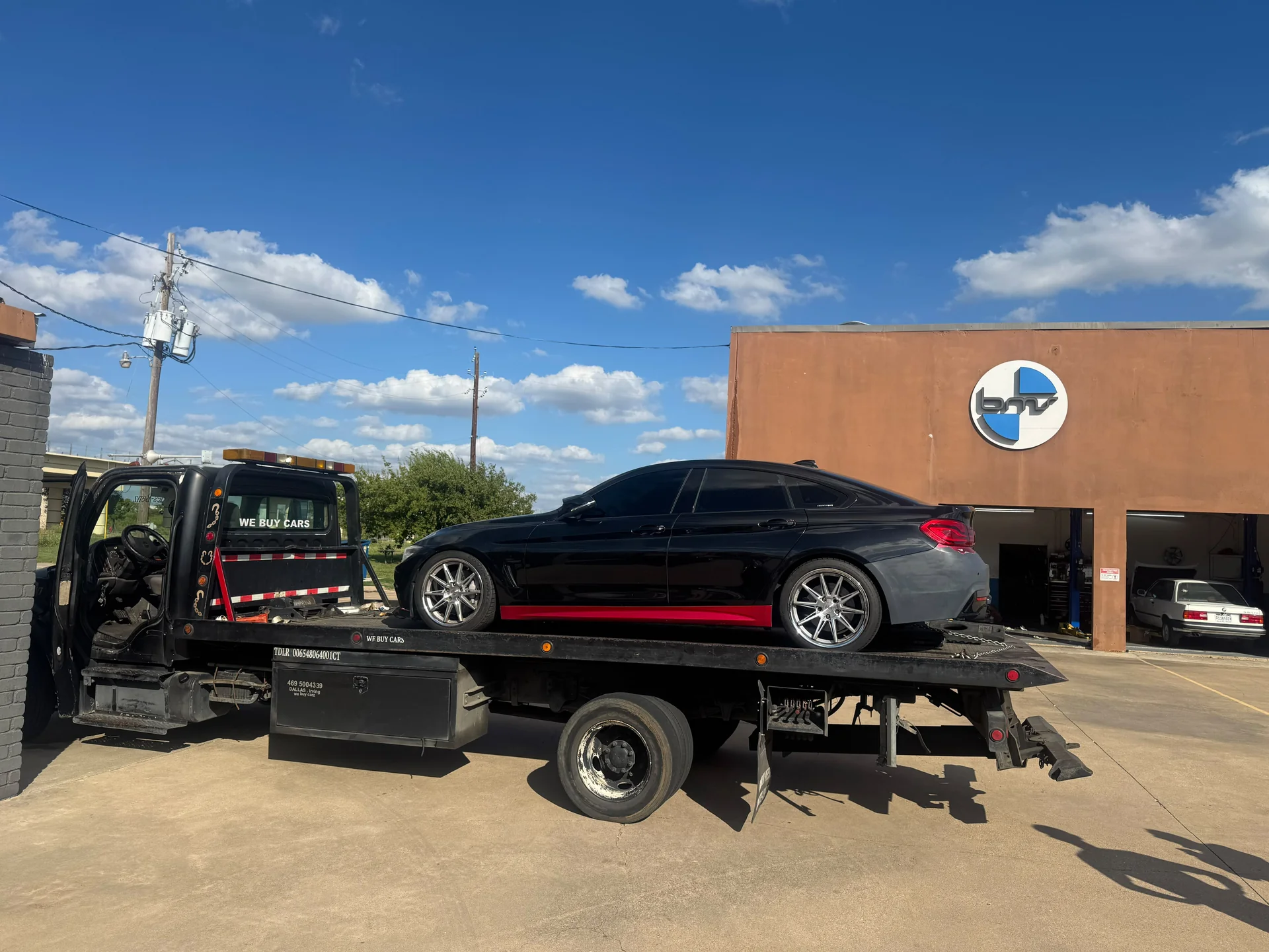 West Dallas Towing - Flatbed Towing Service Dallas TX West Dallas Towing flatbed truck towing BMW custom sedan in Dallas TX